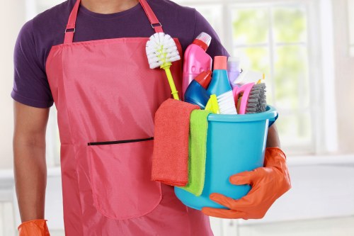 Domestic cleaner tidying a Westminster apartment living room